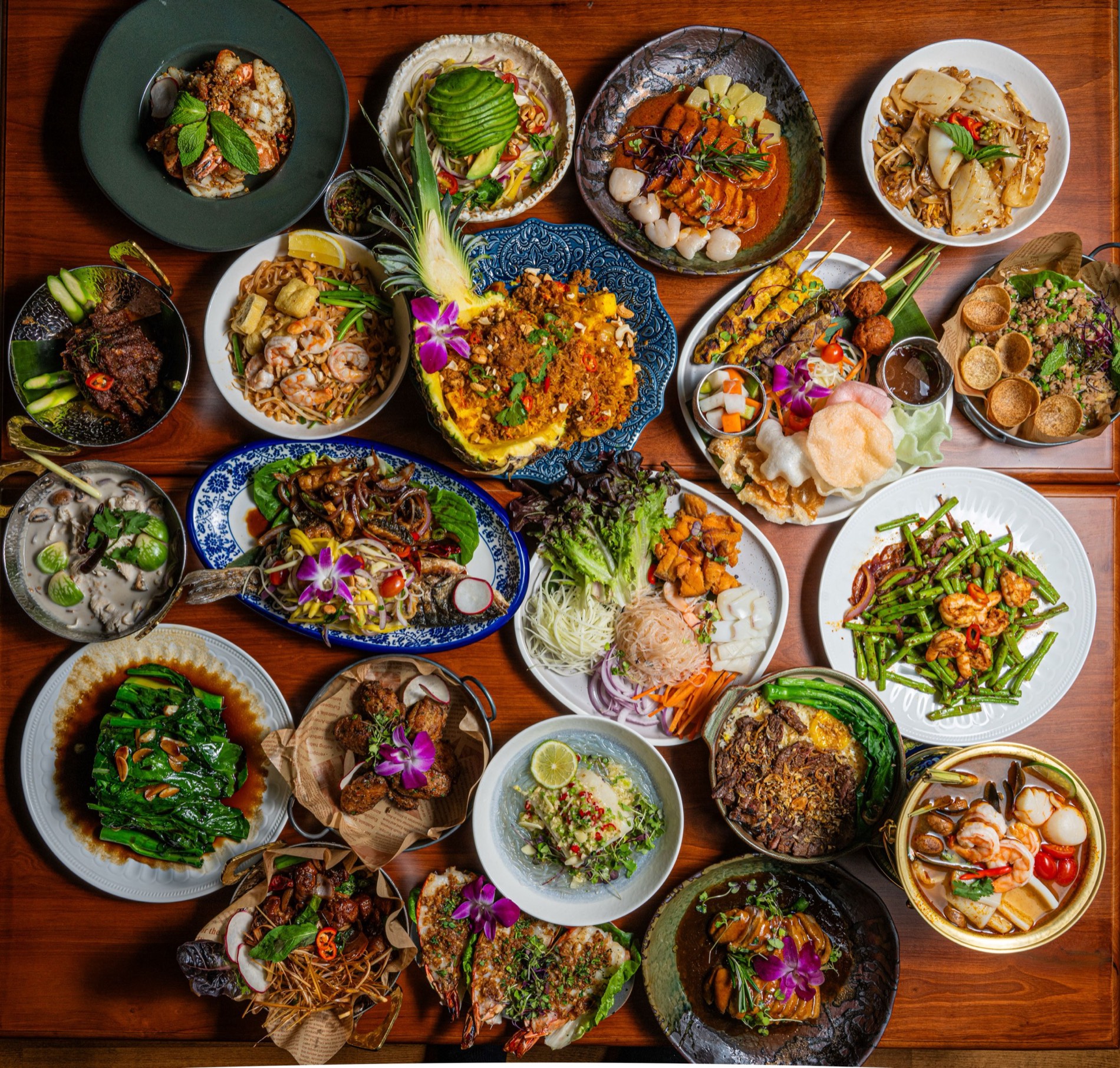An overhead spread of vibrant Thai dishes at Elephant Ear in NYC's Theater District