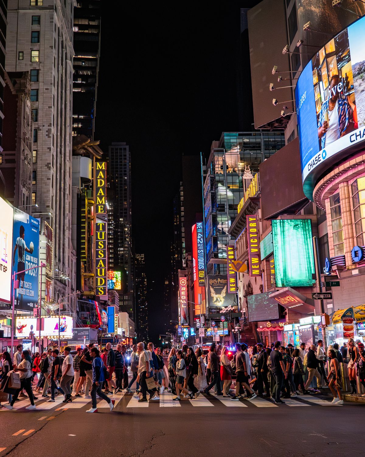 West 42nd Street theater district lit up at night near Times Square, steps from Elephant Ear Thai Restaurant